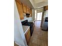 Functional kitchen with gas range, tiled countertops and flooring, and ample cabinet space at 149 Cologne Ct, Henderson, NV 89074
