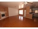 Expansive living room featuring gleaming hardwood floors, a fireplace, and plenty of natural light at 1900 N Torrey Pines Dr # 225, Las Vegas, NV 89108