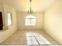 Bright dining room with tiled floors and a large window, perfect for Gathering gatherings at 1906 Double Delight Ave, North Las Vegas, NV 89032