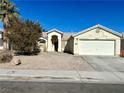 Charming single-story home with a well-maintained xeriscaped front yard and two-car garage at 1906 Double Delight Ave, North Las Vegas, NV 89032
