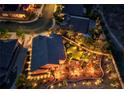 Aerial night view of property showing the backyard putting green, landscaping, and outdoor seating areas at 2064 Poetry Ave, Henderson, NV 89052