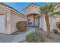 Inviting front entrance with a charming desert landscape and a cozy courtyard at 225 Deer Crossing Way, Henderson, NV 89012