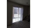 Living room with sliding doors, carpet, and stairs at 2290 Desert Inn, Las Vegas, NV 89169