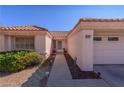 Inviting front entrance with a tiled roof, landscaped walkway, and desert accents at 2456 Desert Sands Dr, Las Vegas, NV 89134