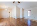Spacious living room featuring gleaming hardwood floors and a decorative light fixture at 2456 Desert Sands Dr, Las Vegas, NV 89134