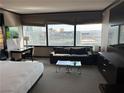 Bedroom area with a sofa and large windows showcasing the expansive city views at 2600 W Harmon Ave # 25019, Las Vegas, NV 89158