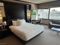 Bright bedroom featuring a king-size bed, workspace, and a city view at 2600 W Harmon Ave # 25019, Las Vegas, NV 89158