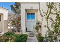 Welcoming front entrance with decorative door and lush greenery, creating curb appeal at 2632 Starfish Ct, Las Vegas, NV 89128
