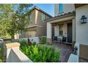 Inviting front porch with outdoor seating and decorative landscaping, providing a warm welcome at 27 Parco Fiore Ct, Henderson, NV 89011