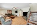 Cozy living room with hardwood floors, ceiling fan, and staircase at 3261 Ennis Ct, Las Vegas, NV 89121
