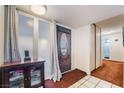 Entryway with decorative wood door, tile and carpet flooring, and cabinet at 3994 Ridgewood Ave, Las Vegas, NV 89120