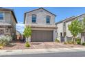 Charming stucco home with a 2 car garage, paver driveway and mature landscaping at 406 Misterioso St, Henderson, NV 89011