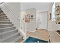 Bright foyer with staircase, featuring wood flooring, neutral walls, and an inviting, open layout at 4163 Peaceful Meadow St, Las Vegas, NV 89135