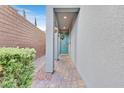 Inviting covered entryway featuring a stylish front door, brick-paved path, and decorative wreath accent at 4163 Peaceful Meadow St, Las Vegas, NV 89135