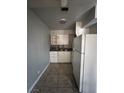 Small kitchen with white appliances, cabinets, and tiled floor at 500 S 13Th St # C27, Las Vegas, NV 89101