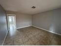 Living room featuring neutral-toned walls, tiled floor and access to another room at 500 S 13Th St # C27, Las Vegas, NV 89101