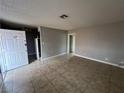 Living room featuring neutral-toned walls and tiled floor, illuminated by ceiling light at 500 S 13Th St # C27, Las Vegas, NV 89101