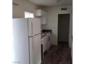 Cozy kitchen featuring white appliances, cabinets and light countertops at 5126 Golden Ln # A, Las Vegas, NV 89119