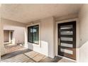 Inviting front porch featuring a modern front door with glass panels and side window at 5537 Sentinel Bridge St, Las Vegas, NV 89130