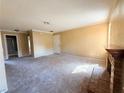 Spacious living area with fireplace, neutral carpet, and access to other rooms at 5576 W Rochelle Ave # 38B, Las Vegas, NV 89103