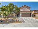 Charming two-story home with desert landscaping, a two-car garage, and a welcoming entrance at 6031 Colonial Oak Ct, North Las Vegas, NV 89031