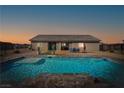 Stunning backyard featuring a refreshing pool, lounge area, and desert landscape with mountain views at 6101 Cavalry Trl, Pahrump, NV 89060