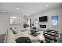 A beautifully staged living room featuring a decorative fireplace, plush sofa, and modern furnishings at 6109 W Oakey Blvd # C, Las Vegas, NV 89146