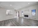 Bright living room featuring a fireplace, wood floors, and plenty of natural light at 6109 W Oakey Blvd # C, Las Vegas, NV 89146