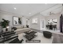 Bright living room featuring a ceiling fan and a small kitchen visible through an archway at 6109 W Oakey Blvd # C, Las Vegas, NV 89146