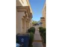 Townhome exterior featuring walkway between buildings and mature landscaping at 6425 Extreme Shear Ave # 101, Henderson, NV 89011