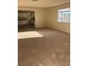 Bright and open living room features neutral walls and natural light from a large window at 664 Sky Rd, Indian Springs, NV 89018