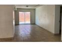 Living room with sliding glass doors to the back and tile floors at 7732 Blackbird Ave, Las Vegas, NV 89145
