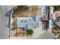 Bird's eye view of the property showcasing its roof, backyard with white fencing, and surrounding neighborhood at 7797 Hauck St, Las Vegas, NV 89139