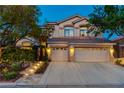 Charming two-story home featuring a three-car garage and a beautifully landscaped front yard at 812 Eaglewood Dr, Las Vegas, NV 89144