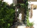Charming front gate adorned with lush greenery and a decorative wrought iron design at 812 Eaglewood Dr, Las Vegas, NV 89144