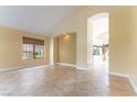 Spacious living room with neutral paint and flooring, as well as an archway leading to other rooms at 812 Eaglewood Dr, Las Vegas, NV 89144