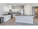 Bright kitchen features granite counters, stainless appliances, and a large island at 9871 Magnus Ct, Las Vegas, NV 89178