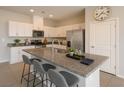 Modern kitchen featuring an island with bar seating, stainless steel appliances, and granite countertops at 9871 Magnus Ct, Las Vegas, NV 89178