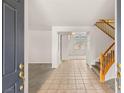 Inviting foyer with tile flooring, staircase and ample natural light at 10501 Haywood Dr, Las Vegas, NV 89135