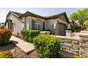 Charming single-story home featuring stone accents, a well-kept lawn, and a welcoming facade at 11253 Piper Peak Ln, Las Vegas, NV 89138