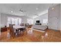 Bright, spacious living room with hardwood floors, large windows with plantation shutters, and a dining area at 1319 Highland Ct, Boulder City, NV 89005