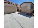 Exterior view of a single-Gathering home with a wide driveway leading to two attached garages at 1540 Sabatini Dr, Henderson, NV 89052