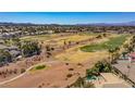 Aerial view of the golf course community with palm trees and stunning mountain backdrop at 165 Inveraray Ct, Henderson, NV 89074