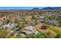 Beautiful aerial view showcasing the pool, golf course, and mountain views at 165 Inveraray Ct, Henderson, NV 89074