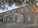 A low angle shot of an apartment complex exterior featuring covered entranceways and gravel landscaping at 2011 Sue Ct # 203, Las Vegas, NV 89108