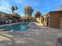 A community pool with lush landscaping and a clear blue sky overhead at 2011 Sue Ct # 203, Las Vegas, NV 89108