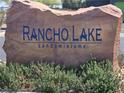 Rancho Lake Condominiums entrance sign made of stone surrounded by green foliage at 2011 Sue Ct # 203, Las Vegas, NV 89108