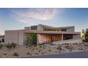 Charming modern home with desert landscaping, stone accents, and unique architectural details at 21 Rockstream Dr, Henderson, NV 89012