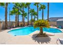 Backyard swimming pool with palm trees and hot tub, perfect for outdoor entertaining at 2290 Casa Bella Ct, Las Vegas, NV 89117