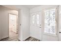 Bright entryway with white walls, plank flooring, shuttered windows, and stylish front door at 2824 Dry Plains Dr, Las Vegas, NV 89134